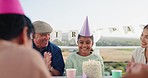 Birthday party, excited and family clapping hands for the girl to blow candles on her cake in the garden. Happy, smile and young child and group of people in celebration at outdoor event together.