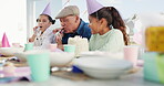 Celebration, party horn and children with grandfather for birthday, playing and together at a table. Happy, home and kids with a senior man and playful to celebrate with decorations with a smile