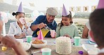 Grandfather, birthday and girl in park with juice for picnic, celebration and party event outdoors for social gathering. Family, food and mother, grandpa with children with cake, presents and drink