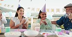 Happy, celebration and girl in park for birthday, picnic and party event outdoors for social gathering. Family, lunch and mother, grandfather with children clapping with cake, presents and surprise