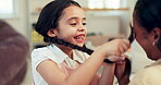 Happy, playful and child with mother and hair for bonding, playing and comedy in a house. Smile, excited and a young girl with pigtails to tickle a mom, care and funny together in the living room