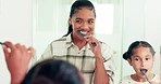 Mirror, mother and girl brushing teeth, wellness or dental hygiene in a bathroom, bonding or smile. Happy, mama or daughter with toothpaste, reflection or child development with oral care or learning