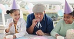 Family, children laugh and happy grandfather with cake on patio with party horn and celebration. Blowing, young kids and old man with a smile ready to celebrate with youth, food and birthday event