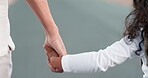 Love, trust and a girl holding hands with her parent while walking together outdoor on the road closeup. Family, children and an adult on the street with a daughter for guidance or bonding in summer