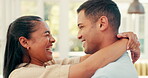 Laughing, face and a happy couple embrace at home with love, care and romance. Young woman and a man together in an apartment to hug, relax and bond for happiness, quality time and commitment