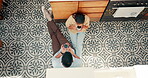 Coffee, talking and a couple at home with love, care and communication. Young woman and a man drinking tea together to bond during conversation and quality time on a floor with tiles from above