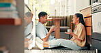 Coffee, talking and a happy couple at home with love, care and communication. Young woman and a man drinking tea together in an apartment to bond for happiness, quality time and commitment on a floor