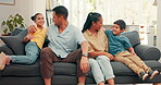 Family, tickle and children with parents in a living room at home for comfort. Young kids, happy man and woman or mom and dad together for fun, happiness and love while playing and bonding on a sofa