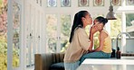 Mother, kiss and child ready for school on a kitchen table with a backpack and books. Woman, girl kid and together at family home to prepare for education or learning with love and care of young mom