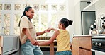 Kitchen, bonding and mom dancing with her child to music, song or album for having fun together. Happy, goofy and young mother singing and doing a dance to a playlist with her girl kid at family home