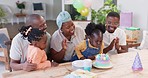 Children, blow candles and family for birthday party celebration and clapping, cheers or excited at home. Happy african people, kids or girl and cream cake on patio table for holiday dessert and food