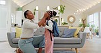 Talking, happy and a mother with a child getting ready for school in the morning. Kiss, laughing and an African mom helping a little girl with a bag in the living room of a house for kindergarten