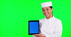 Tablet, culinary and a woman chef on green screen background in studio holding a display with tracking markers. Portrait, cooking website and a happy young asian female cook holding chromakey