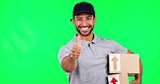 Asian man, boxes and thumbs up on green screen for delivery success against a studio background. Portrait of happy male person in logistics with thumb emoji, yes sign or like for approval on mockup