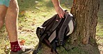 Backpack, travel and man in park for walking on adventure, holiday and vacation in nature. Relax, morning and male person with bag for trekking, hiking and journey in natural environment in summer