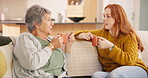 Communication, mother with daughter talking and on sofa in living room of their home. Networking or consulting, bonding time with coffee or discussion and people have a conversation on couch