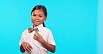 Happy, spin and uniform of a child on a blue background for school, education and showing shirt. Smile, space and face portrait of a girl in student clothes isolated on a mockup studio backdrop