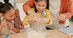 Family, parents and girls baking, happy and skills with ingredients, excited and learning in a kitchen. Mother, father and female children with a recipe, home and excitement with utensils or teaching