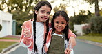 Peace, family and sister with sibling children outside on the street together in their residential neighborhood. Portrait, love and hand gesture with happy female kids bonding on an asphalt road