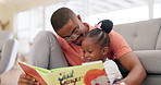 Reading, father and story with girl for learning in lounge for education or quality time. Kid, books and parent for support on floor or fun with growth for childhood at house with happy family.