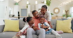 Happy, black family on sofa and in living room of their home happy together for care. Support or love, happiness or positivity and African people cuddle on couch in their house for bonding time