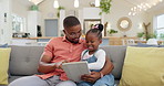 Family, man with child and tablet on sofa living room of their home for social media. Technology or internet, connectivity or bonding time and black man with his daughter together playing a game