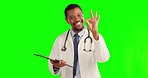 Black man, doctor and okay sign with clipboard on green screen for success against a studio background. Portrait of African male person or medical professional and OK hand gesture for perfect results