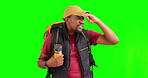 Search, lost and travel with black man on green screen for hiking, backpacking and location. Confused, frustrated and direction with person on studio background for adventure, vacation and navigation