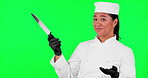 Chef, woman and hand with a knife on a green screen with list, menu or choice for career or food. Asian person or cook with tools for cooking, marketing or advertising step, information or checklist