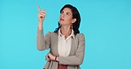 Business thinking, pointing and studio woman gesture at sales product space, retail planning or corporate announcement. Options, decision and professional person question choice on blue background