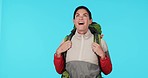Travel, hiking with wow and woman in studio, adventure to watch nature and smile on camping holiday. Trekking, sightseeing and happy hiker, relax and view on vacation with backpack on blue background