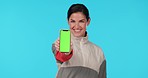 Woman, phone and smile by green screen in studio with face, mockup or excited for promo by blue background. Lady, model and show smartphone with tracksuit for sport app, logo and branding in portrait