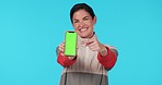 Woman, point and phone green screen in studio with face, mockup and ok sign for promo by blue background. Lady, model and show smartphone with tracksuit for sport app, logo and branding in portrait