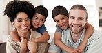 Love, hugging and face of a family on a sofa for relaxing, bonding and spending time together. Happy, smile and portrait of cute boy children embracing their young interracial parents at modern home.