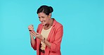 Woman, fist and phone in studio for surprise success, profit and bonus on fintech app by blue background. Entrepreneur lady, smartphone and happy winner with goal, investment and lotto promotion