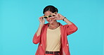 Sunglasses, fashion and peace with a model woman in studio on a blue background for trendy style. Portrait, shades and hand gesture with a happy young female person posing in a clothes outfit