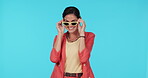 Sunglasses, fashion and blow a kiss with a woman in studio on a blue background for trendy style. Portrait, eyewear and smile with a happy or playful young female model flirting in a clothes outfit