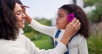 Flowers, love and mother and girl in nature for bonding, quality time and relaxing outdoors together. Happy family, smile and mom giving child flower for loving relationship, affection and care