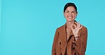 Business woman, ok sign and pointing in studio for advertising, presentation or review. Portrait of a happy female model show space or choice for okay hand emoji for announcement on a blue background