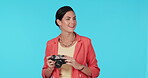 Photography, camera and a woman tourist on a blue background in studio for travel sightseeing. Smile, picture and tourism with a happy young female photographer overseas for a vacation or holiday