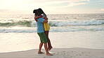 Ocean, sunset and indian couple with hug or love for bond on weekend with travel for relaxing. Couple, romance and beach with embrace on vacation or summer with quality time in outdoor or together.