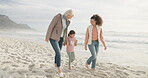 Mother, grandma and girl holding hands at beach, walking and bonding on vacation to travel. African mom, kid and care of grandmother by ocean, happy and enjoying quality time together at sea holiday.