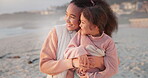 Hug, mother and child on the beach for sunset, ocean view and bonding in the morning. Happy, relax and a mom and little girl with an embrace and affection watching the sunrise by the sea together