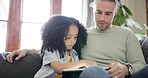 Learning, digital tablet and father with child on a sofa for search, games and bonding in their home together. Love, parent and kid in a living room online for teaching, child development and play