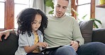 Family, digital tablet and father with child on a sofa for learning, games and bonding in their home together. Love, parent and kid in a living room online for teaching, child development and play