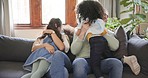 Family, parents and children hug on sofa for bonding, quality time and relaxing in living room. Happiness, playful and mother, father and kids at home having fun on couch for embrace, cuddle and love