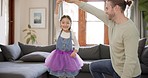 Love, happy father and girl dance in living room for bonding, quality time and dancing at home. Family, playful and dad spin daughter for having fun, learning and teaching moves for loving bond