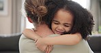 Love, face and girl child hugging mother on a sofa sweet, happy and bonding in their home together. Smile, care and comfort by kid embracing parent in a living room, relax and enjoying family time