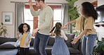 Family, happy parents and children on sofa for bonding, quality time and dancing in living room. Happiness, playful and mother, father and kids at home having fun with dance, tablet and relaxing