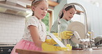 Water, cleaning and children learning with dishes in kitchen or sister, girl or helping to wash, dry and clean house. Kids, washing and cloth to wipe plates, cutlery or teaching housework to girls